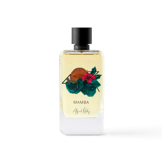 A bottle of MAMBA Eau de Parfum by Alfred Ritchy features a black cap, a red flower, green leaves, and a brown circle on the front. The design includes the brand name, with jasmine notes in its scent.