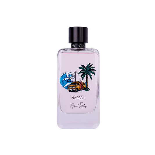 A clear 100ml NASSAU Eau de Parfum by Alfred Ritchy has a wave, palm trees, and yellow jeep illustration on the label. The black-capped bottle against white hints at its pink sand fragrance.