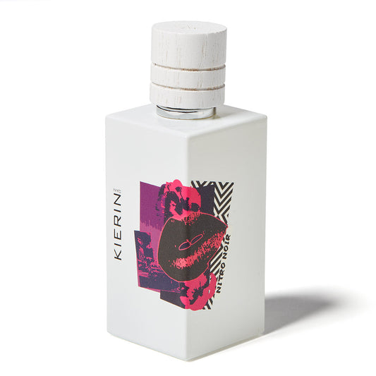 A white rectangular Nitro Noir Eau de Parfum bottle by Kierin features a wooden cap, abstract art, and distinctive branding. The design evokes luxury and bold scents like Italian Bergamot on a white background.