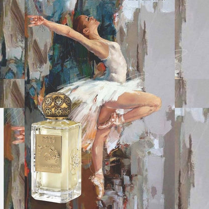 The LA DANZA DELLE LIBELLULE EDP by Nobile 1942, with its ornate gold cap, sits before an artistic painting of a ballerina in a white tutu, evoking the elegance and sweetness of this gourmand fragrance.