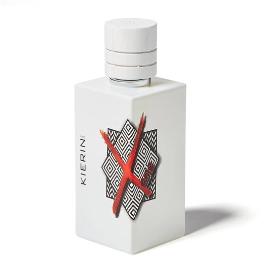 ScentXOne Eau de Parfum by Kierin features a white rectangular bottle with a black-and-white geometric pattern, a striking red X on the front, and KIERIN NYC on the side—perfect for luxury fragrance lovers.