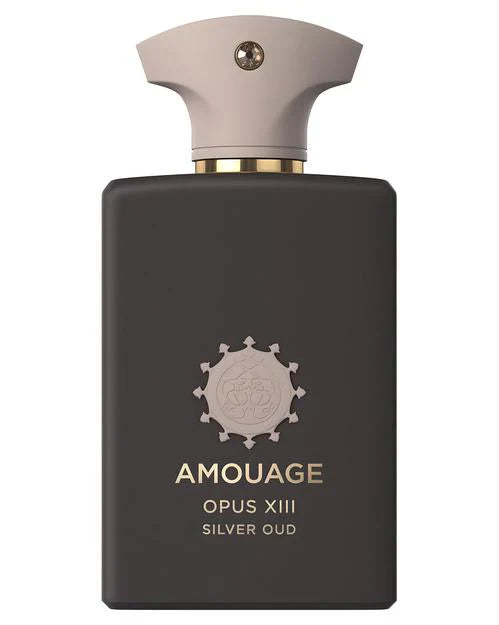 A matte black rectangular perfume bottle with a beige cap, featuring the brand Fragrapedia Haus and the name Opus XIII Silver Oud Eau de Parfum - Amouage in gold lettering on the front.