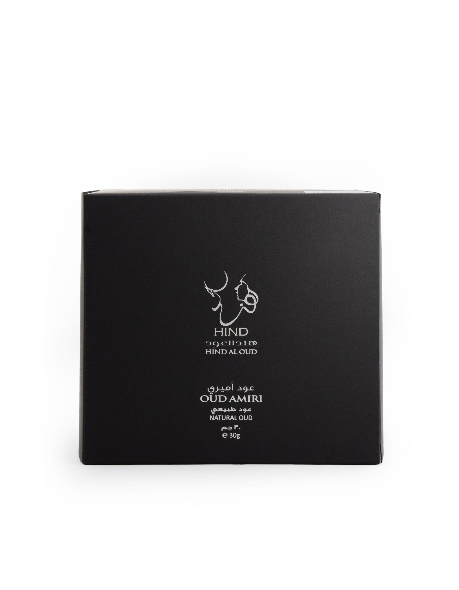 A black square box with white Arabic and English text—Hind Al Oud and Oud Amiri Natural Oud—plus a minimalist animal-heads logo, presents the luxurious scent of premium agarwood from Hind Al Oud.