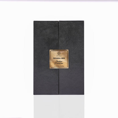 A black rectangular perfume box with a gold label reading Patchouli Noir Eau de Parfum by Christian Provenzano sits elegantly against a white background, showcasing this refined niche fragrance.
