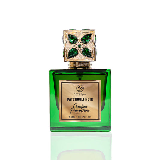 A green glass bottle of Patchouli Noir Eau de Parfum by Christian Provenzano, featuring a gold and green jeweled cap, is displayed on a white background.