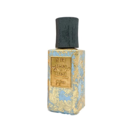 A rectangular PETALI E SPADE Eau de Parfum bottle by Nobile 1942, featuring a textured blue and gold marbled design, black cap, and a gold label engraved with the fragrance name.