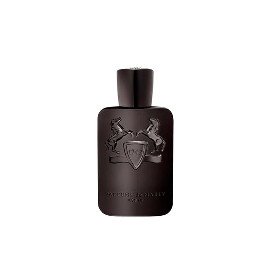 Herod Eau de Parfum by Parfums de Marly comes in a dark brown bottle embossed with two rearing horses and a central shield marked "1743." Near the base, the label reads Parfums de Marly Paris. Herod features rich tobacco and warm vanilla notes.