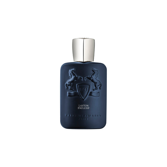 A matte navy blue Layton Exclusive Eau de Parfum bottle by Parfums de Marly, featuring two embossed rearing horses and a shield with a silver cap, stands elegantly against a white background.