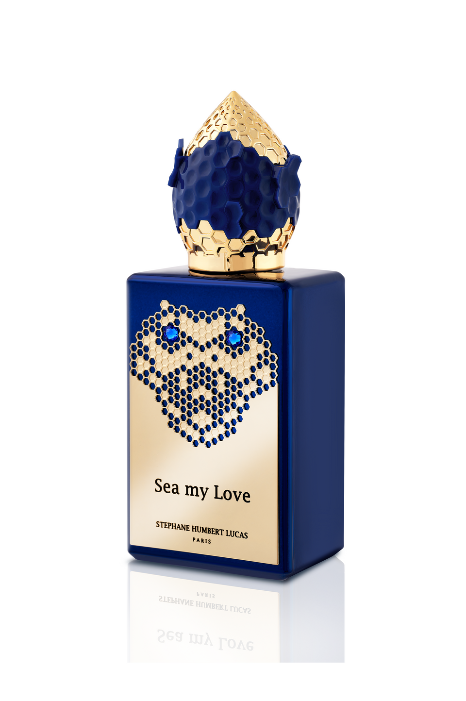 A blue bottle of Sea My Love Eau de Parfum by Fragrapedia Haus features a gold honeycomb-patterned cap and accents, capturing the mysterious depths of an ocean legend.