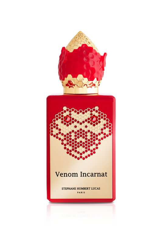 A red perfume bottle with a gold honeycomb design and textured gold-red cap. The label reads “Venom Incarnat Eau de Parfum” by Fragrapedia Haus—a seductive scent with irresistible allure.