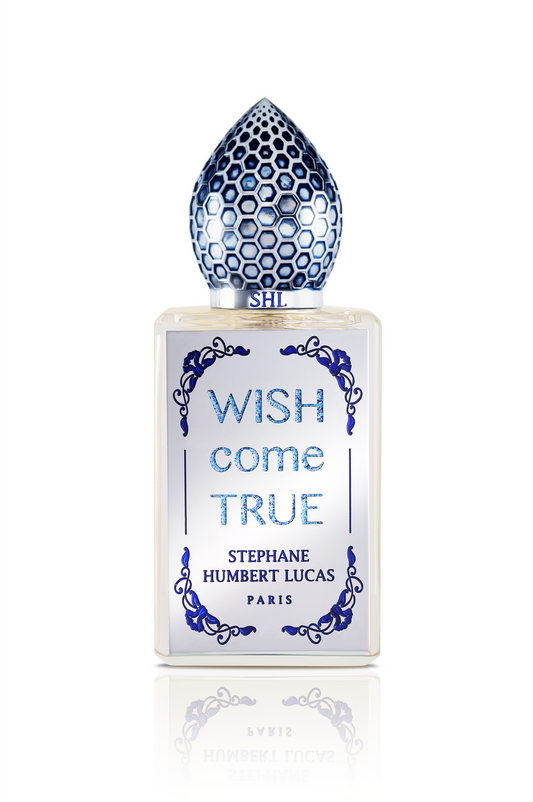 Wish Come True Eau de Parfum by Fragrapedia Haus features a frosted glass bottle adorned with blue, honeycomb-patterned cap and ornate designs, capturing the allure of a magic potion and feminine elegance.