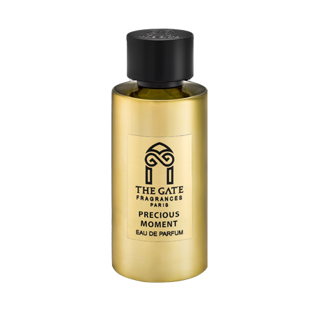 A gold cylindrical bottle of Precious Moment Eau de Parfum by The Gate Paris, featuring a black cap and label, stands elegantly against a light background.