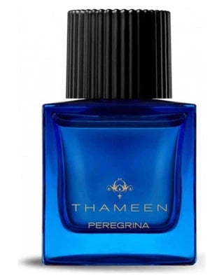 A blue glass bottle labeled Peregrina Extrait de Parfum by Fragrapedia Haus features a large black ribbed cap, gold text, and evokes white floral notes with musk and amber nuances. Inspired by La Peregrina.