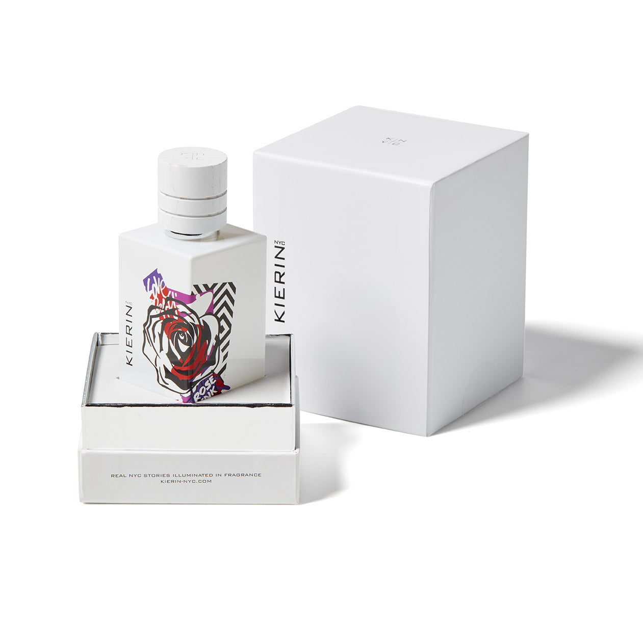 A white bottle with a rose and geometric design sits in an open box beside its lid; Kierin Rose Ink Eau de Parfum is a modern woodsy floral unisex scent. The Kierin brand name is on both the bottle and packaging.