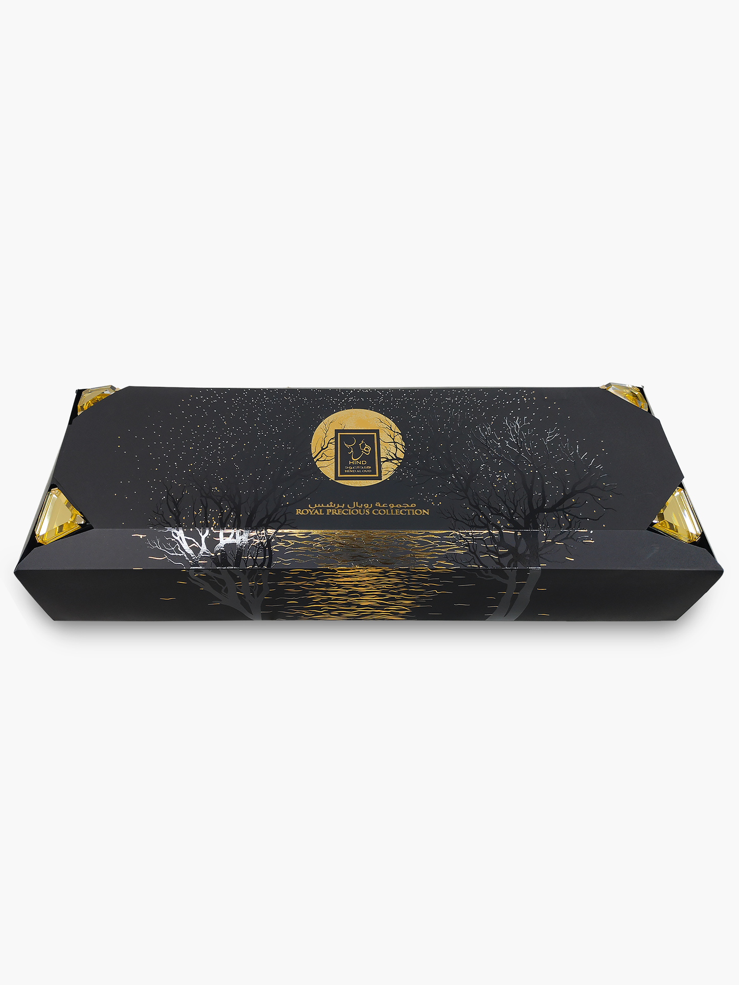 A rectangular black gift box with gold accents, featuring a tree silhouette and gold circular logo reading "Hind Al Oud"—the Royal Precious Collection. A perfect perfume gift set from Hind Al Oud’s luxe range.
