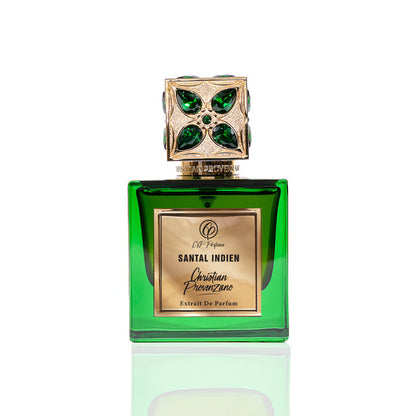 A green glass bottle of Santal Indien Eau de Parfum by Christian Provenzano, topped with a gold cap with green gem accents, captures a luxurious sandalwood scent accented by Tunisian Neroli, set against a white background.