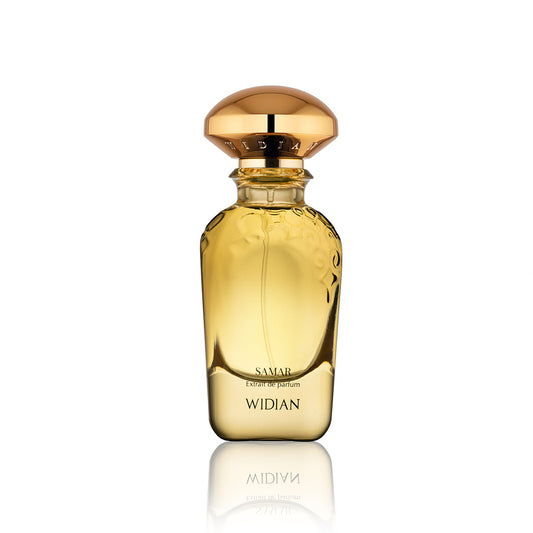 A clear glass bottle of Fragrapedia Haus Samar Extrait de Parfum features an ornate gold cap, golden yellow liquid, and elegant embossed details near the top—hinting at enchanting oud notes—shown against a white background.