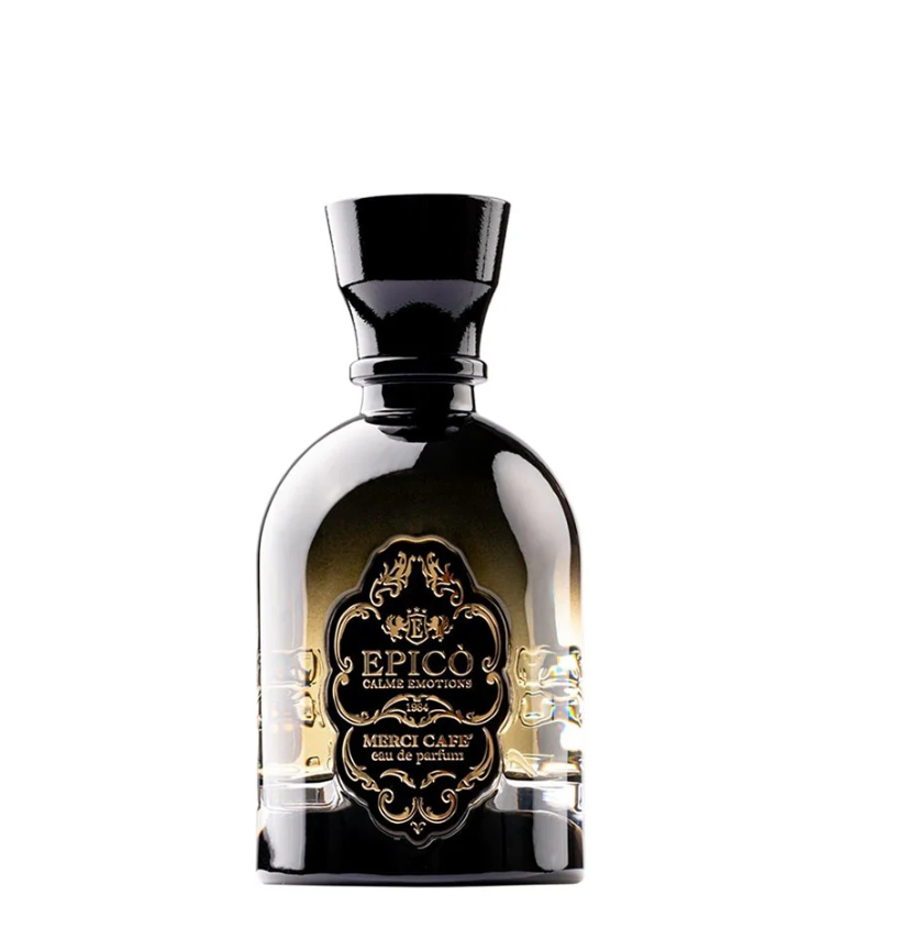 A black and gold perfume bottle labeled EPICO Merci Café Eau de Parfum, with an ornate front design, sits against a white background. This unisex fragrance offers a bold spicy scent with rich coffee notes.