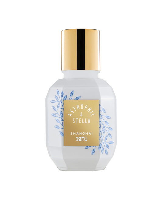 White bottle with gold cap and decorative label on a white background