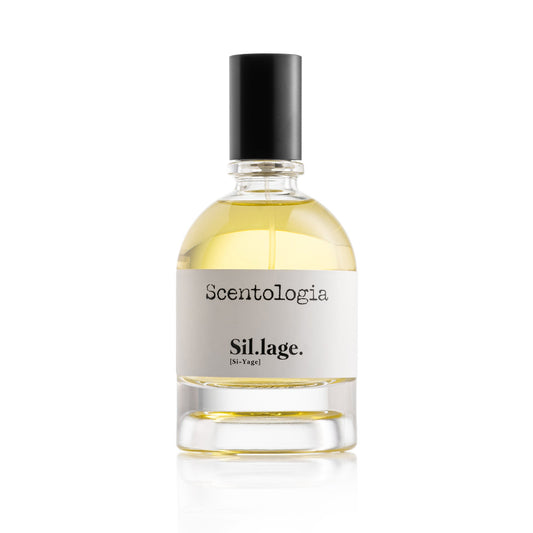 A clear glass bottle labeled Sil.lage. Eau de Parfum - Scentologia, with a black cap and light yellow liquid, set against a white background—an amber fragrance by Scentologia that exudes understated elegance.