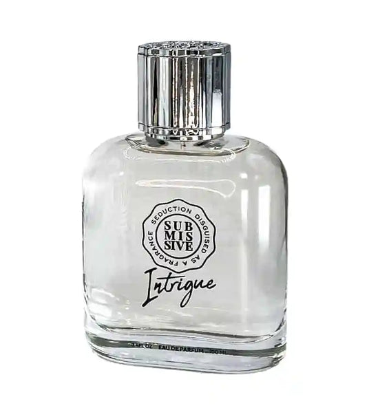 A sleek clear glass bottle of Submissive Intrigue Eau de Parfum by Submissive Perfume features minimalist black text, a shiny silver cap, and suggests notes of sandalwood and bergamot.