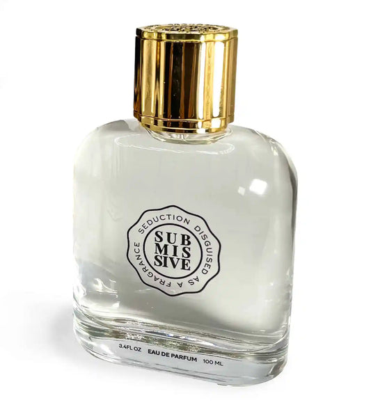 A clear glass bottle with a gold cap, labeled “SUBMISSIVE” by Submissive Perfume. The label reads “Seduction Disguise Fragrance” and suggests floral jasmine notes. Marked as 3.4 FL OZ (100 ML) Eau de Parfum.