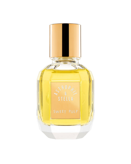 A faceted glass perfume bottle filled with golden-yellow liquid, featuring a metallic gold cap and a peach-colored label with the text 'ASTORHIDE & STELLA' and 'SWEET PULP'.