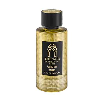 A gold textured bottle of Under Oud Eau de Parfum by The Gate Paris, featuring a black cap and label with gold text and the brand's stylized gate logo.