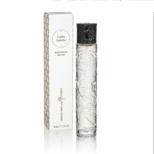 A tall, clear glass bottle of Callis Subtile Dry Oil by Orens Parfums stands beside a white patterned box. This dry oil for body and hair features sweet almond oil and an amber floral scent in a transparent liquid.