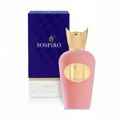 A pink bottle of SOSPIRO Vibranna Eau de Parfum (100 ml), a women’s perfume with powdery luminosity, is displayed with its gold cap and label in front of a matching purple and gold box.