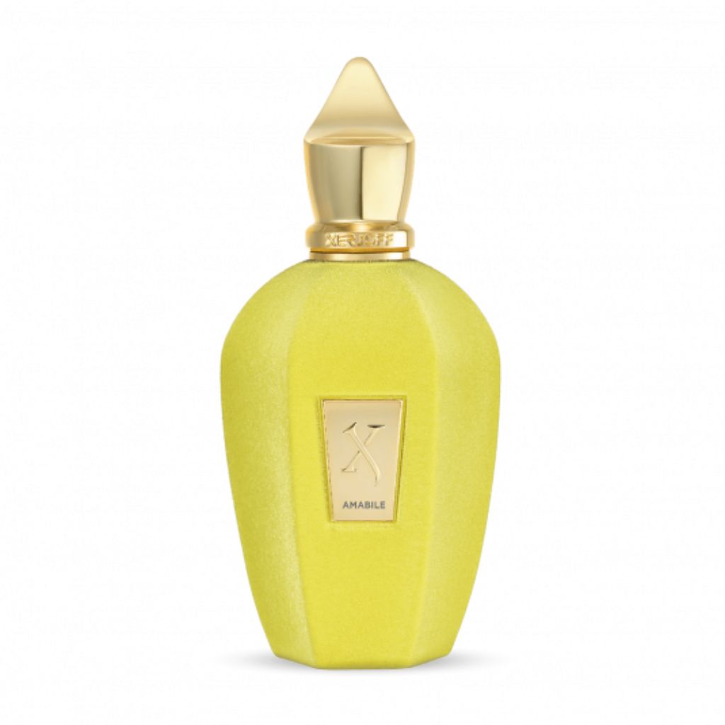 A yellow bottle of XERJOFF Amabile Eau de Parfum with a gold cap and "AMABILE" label features a matte, faceted design, reflecting the elegance of this unisex fragrance renowned for its woody aromatic notes.