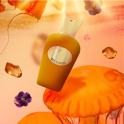A floating golden Bel Canto Eau de Parfum by SOSPIRO appears among orange jellyfish, purple pansies, and amber droplets, suggesting a floral jasmine scent set against a warm, glowing backdrop.