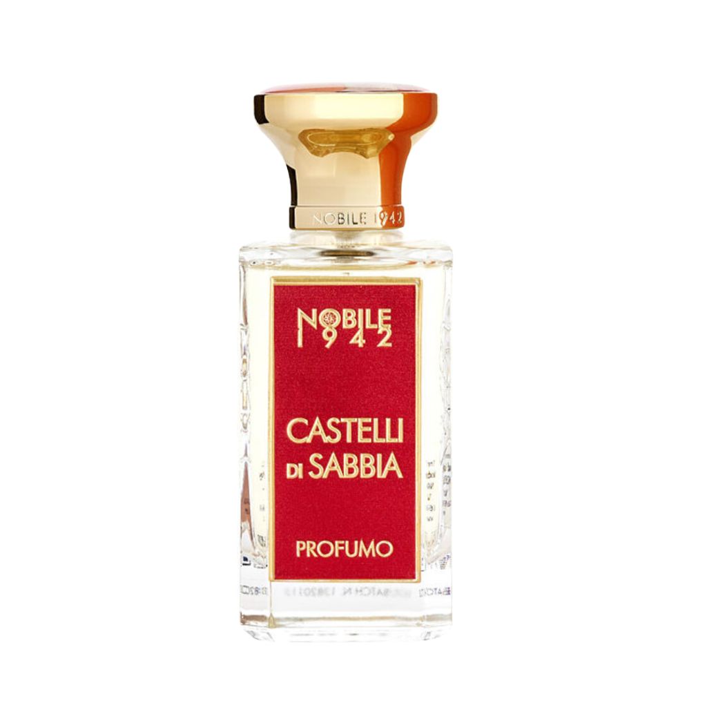 A clear glass bottle with a gold cap and a striking red and gold label displays Nobile 1942’s CASTELLI DI SABBIA Eau de Parfum, photographed against a white background, conjuring images of sand castles and dreams.