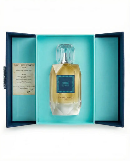 Michael Cinco 'Céloré' Eau de Parfum in an open presentation box with turquoise interior and navy exterior, shown on a white background.