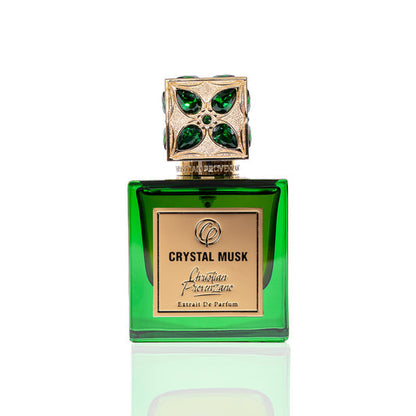 A green glass bottle of Crystal Musk Eau de Parfum by Christian Provenzano features a jeweled gold and green cap, gold plaque branding, and blends musky amber with floral notes. The perfume is pictured on a white background.