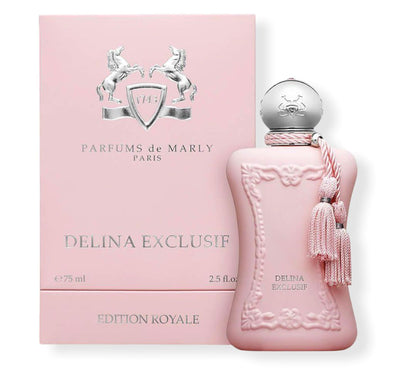 A pink bottle of Delina Exclusive Eau de Parfum by Parfums de Marly stands beside its matching box, featuring silver detailing and elegant embossed designs—a luxurious Turkish rose scent with a silver cap and pink tassel.