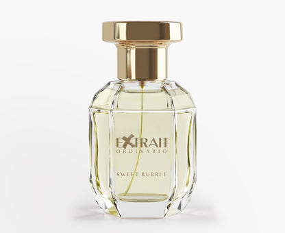 A clear, faceted glass bottle with a gold cap and 'Extrait Ordinario Sweet Bubble' label holds pale yellow Sweet Bubble - Extrait Ordinario perfume, a playful fruity floral scent from Extrait Ordinario, shown on a plain white background.