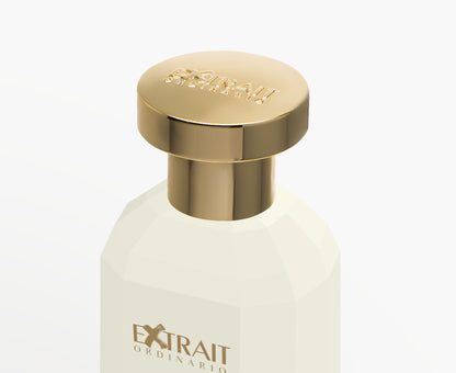 A close-up of Vanilla Superstar by Extrait Ordinario, a white bottle with a shiny gold cap and gold "EXTRAIT ORDINARIO" label. Set against a plain white background, this sweet gourmand perfume stands out for its elegance.