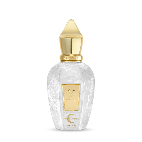 A clear, textured perfume bottle with a gold label and pointed cap displays Fragrapedia Haus and Apollonia Eau de Parfum—an elegant design that suggests notes of white musk and delicate white flowers within.