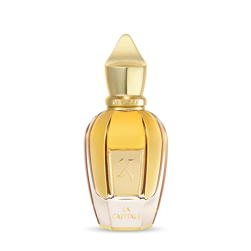A gold-capped, faceted bottle of amber liquid displays a K and "La Capitale." La Capitale Eau de Parfum by Fragrapedia Haus exudes sophistication in its transparent design.