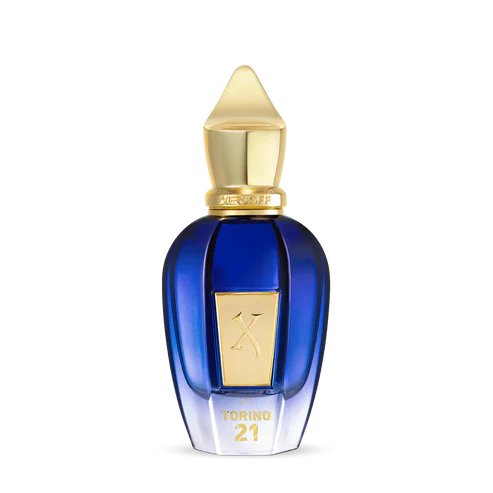 Torino 21 Eau de Parfum by Fragrapedia Haus features a blue and gold bottle with a pointed cap, gold label, and TORINO21 on the front—a luxurious design inspired by the vibrant energy of professional tennis.