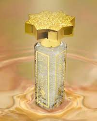 Lamar Caviar Eau de Parfum by Kajal Perfumes Paris, an ethanol-free fine fragrance, comes in a decorative gold and silver bottle with a large ornate eight-pointed star cap, displayed on a swirled golden surface.