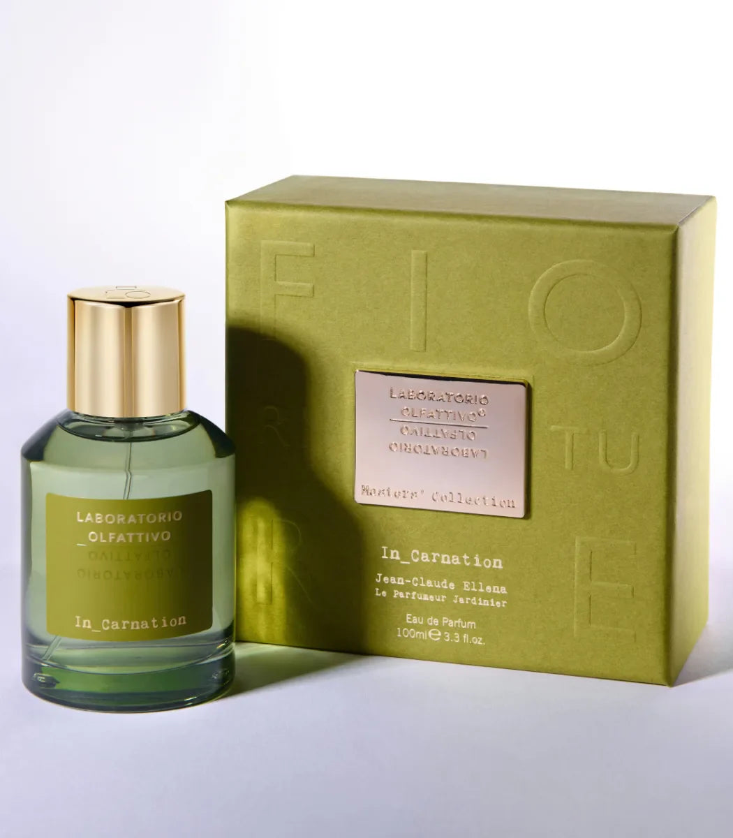 Perfume bottle and packaging with ''In_Carnation Laboratorio Olfattivo'' branding on a light background