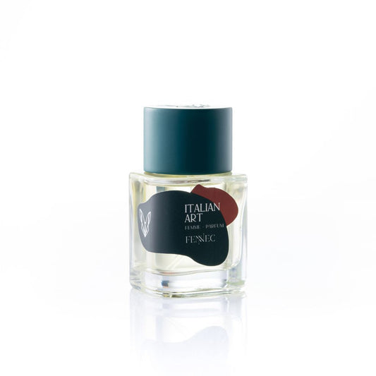 A clear glass perfume bottle with a teal cap from Fennec. The label reads Italian Art Parfum, features abstract dark shapes and a small fennec fox logo on the left, inspired by North African crepuscular foxes. White minimalistic background.