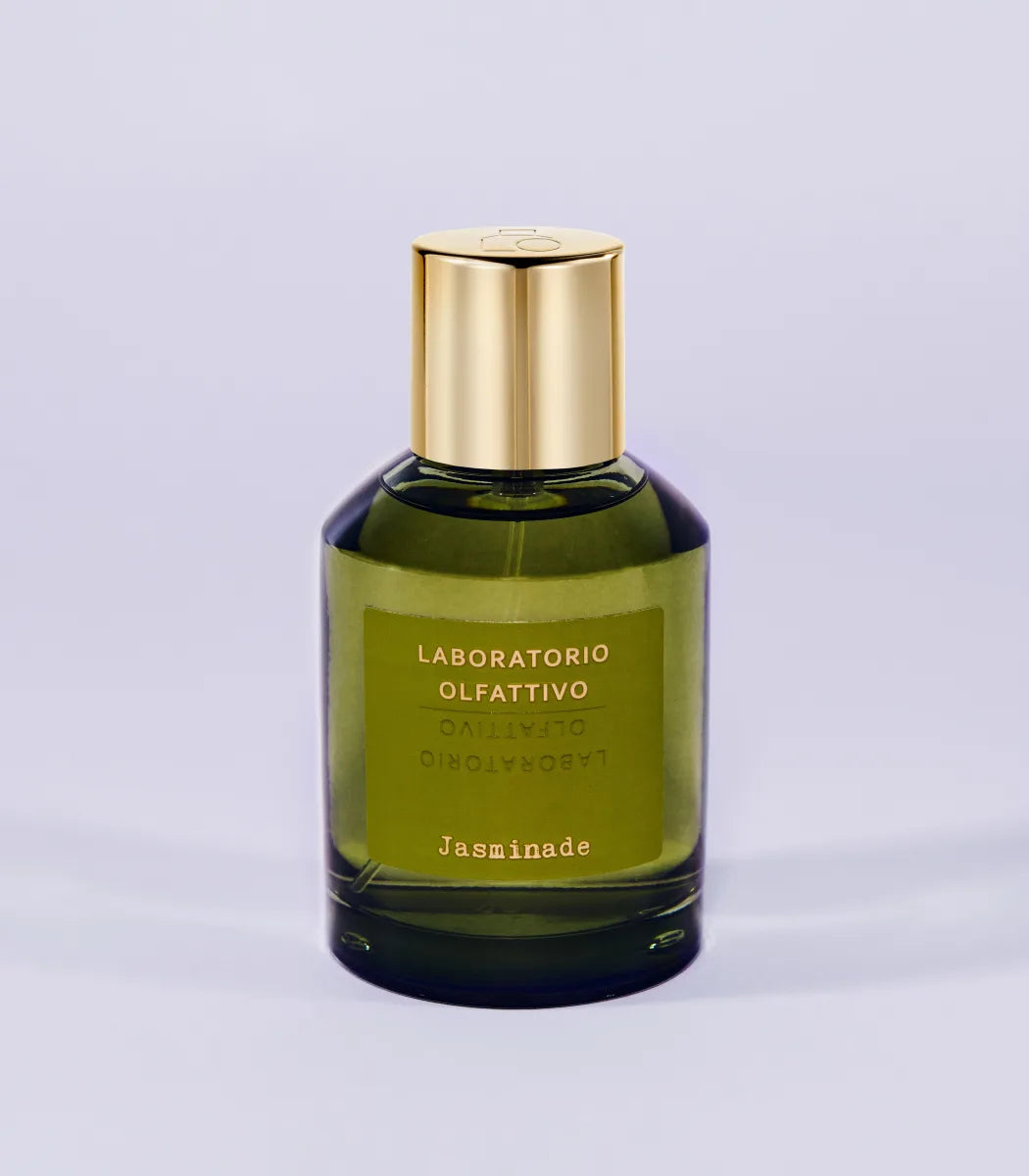 'Jasminade Laboratorio Olfattivo'Green perfume bottle with gold cap on a light gray background