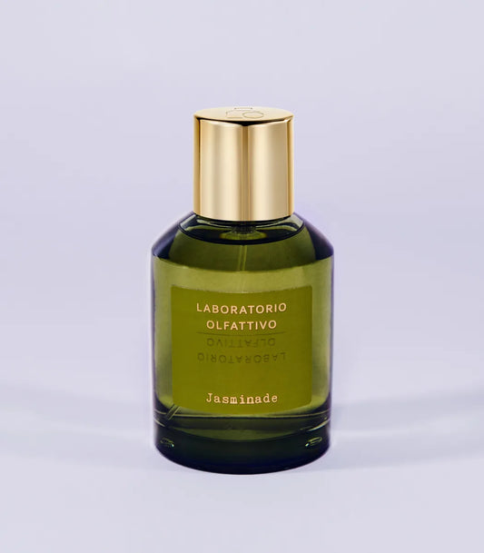 'Jasminade Laboratorio Olfattivo'Green perfume bottle with gold cap on a light gray background