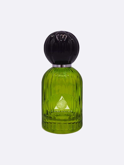A green glass perfume bottle with vertical grooves, a round black cap, and silver band displays a fig illustration and "Capri Extasy" on the label. It's part of the Capri collection by Les Folies du Parfum.