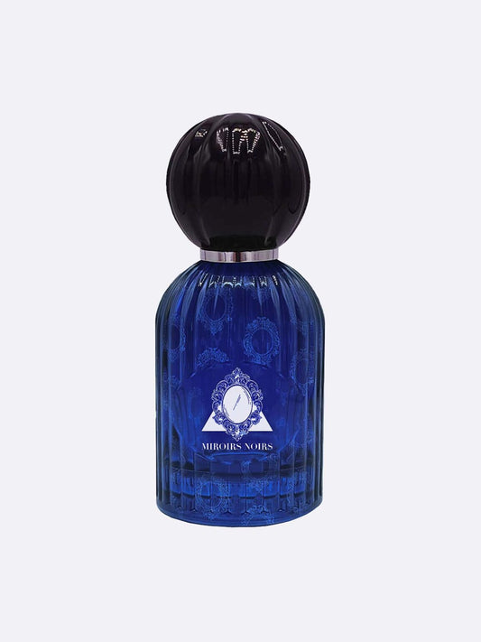A blue, ribbed glass perfume bottle with a large black cap and a white geometric label reading "Miroirs Noirs - Les Folies du Parfum" by Les Folies du Parfum. The background is plain light gray.