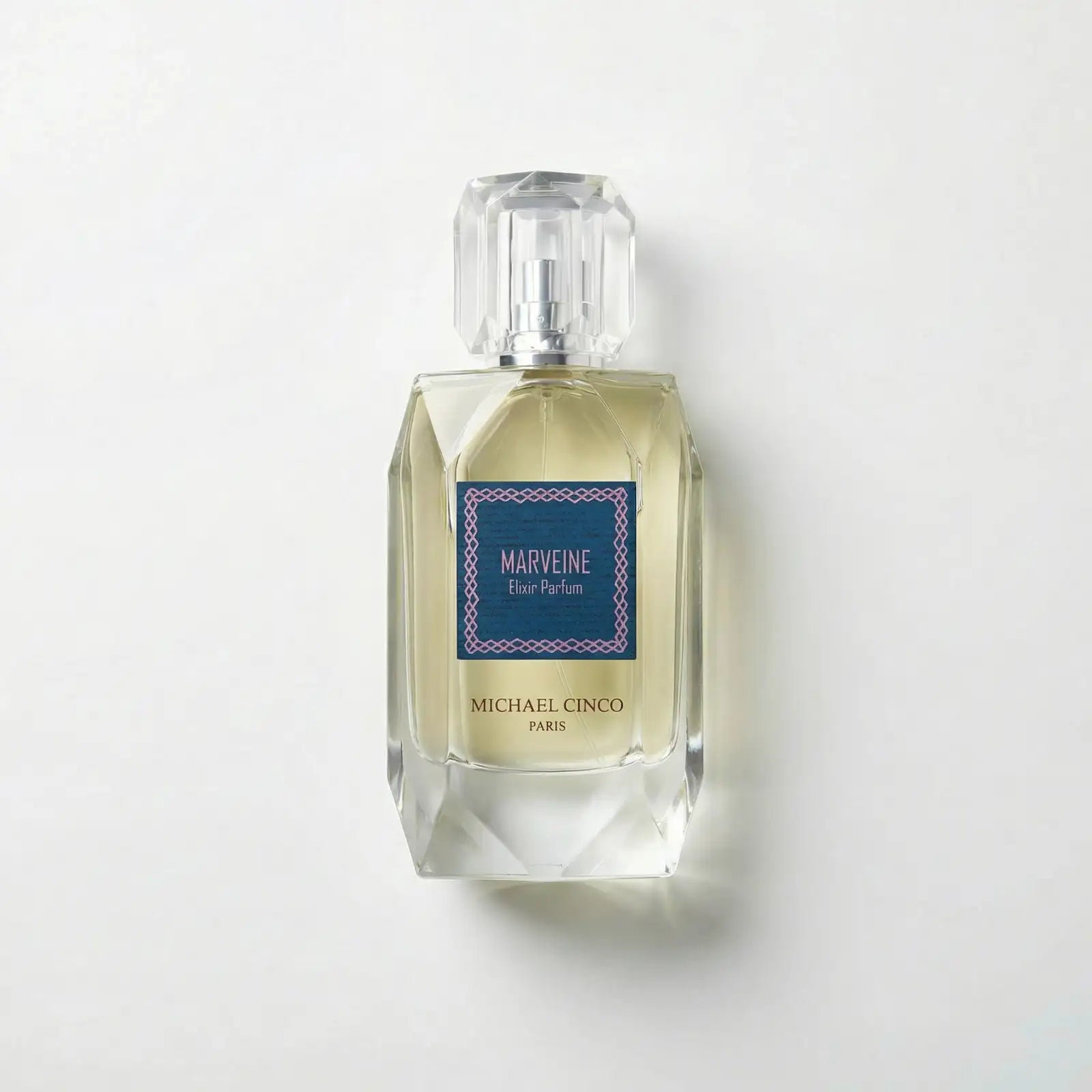Perfume bottle labeled 'Marveine' by Michael Cinco on a light gray background