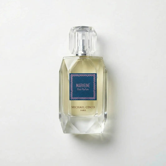 Perfume bottle labeled 'Marveine' by Michael Cinco on a light gray background